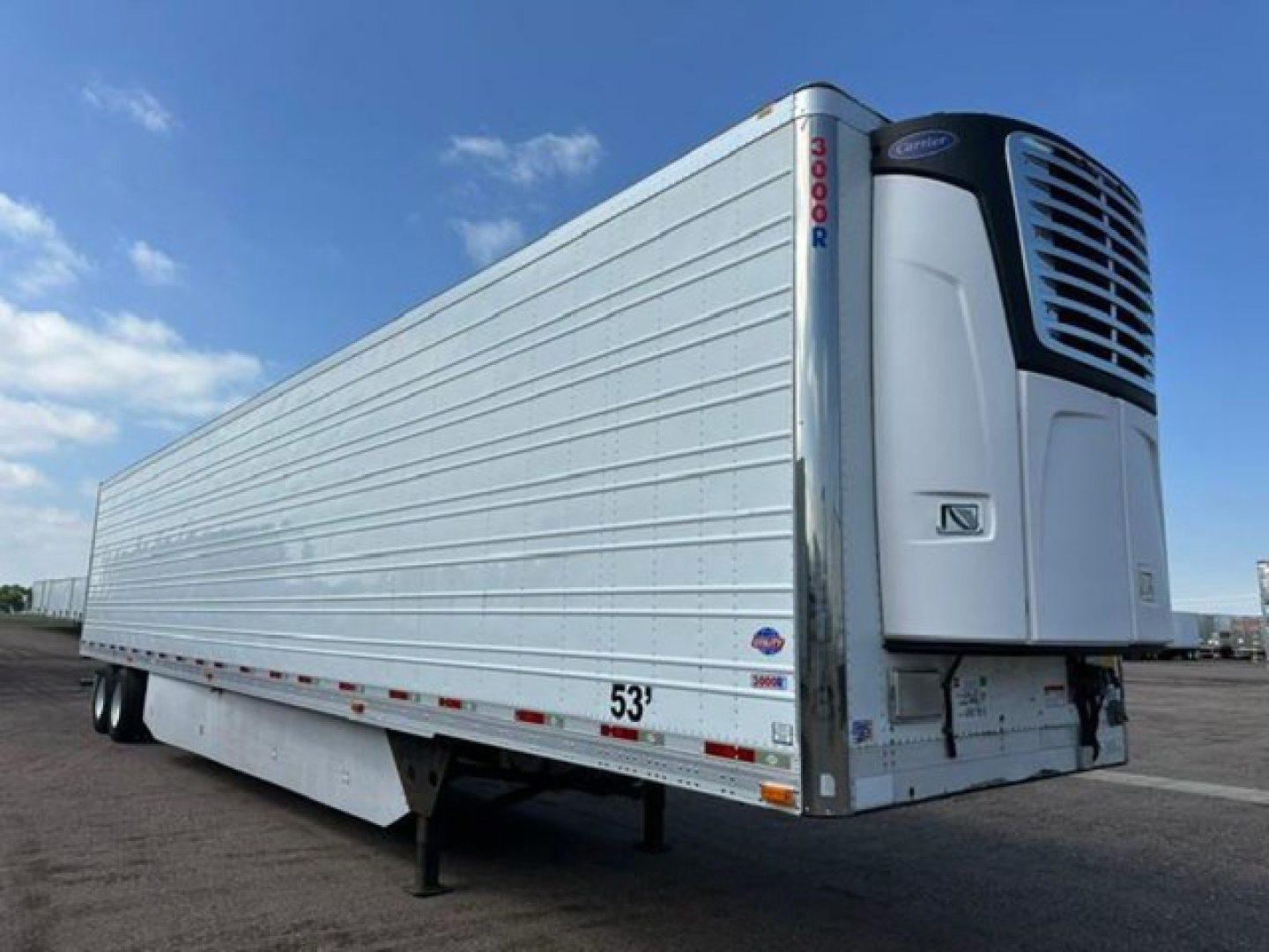 1999 Utility Reefer trailer with refrigeration unit at front showing 53' length and 9000-series model, side view.