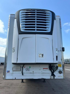 Refrigerated trailer rear showing cooling unit and access doors.