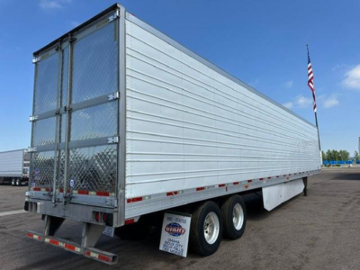 Rear and side view of a 2016 utility refrigerated trailer (reefer) with metal ribbed panels, dual rear doors, diamond plate gate, and spare tire undercarriage. Visible text on a small plate near the back shows stock number and dealer markin
