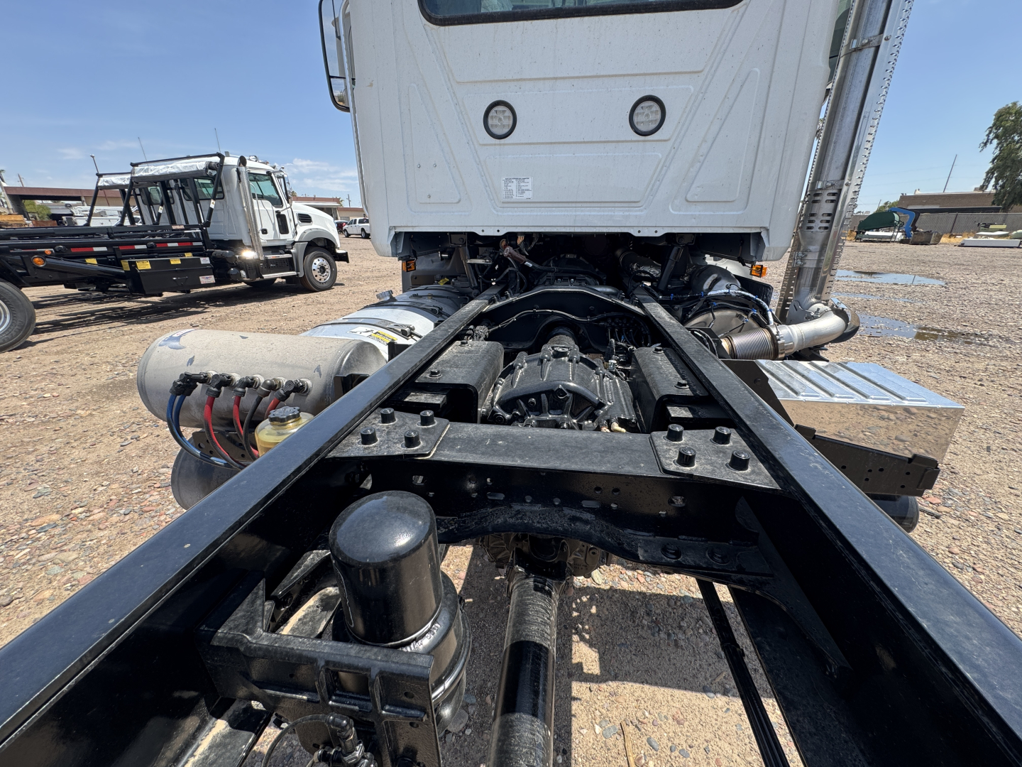 Mack GR44B cab and chassis rear view showing chassis frame and drivetrain components with exposed fuel and air lines.