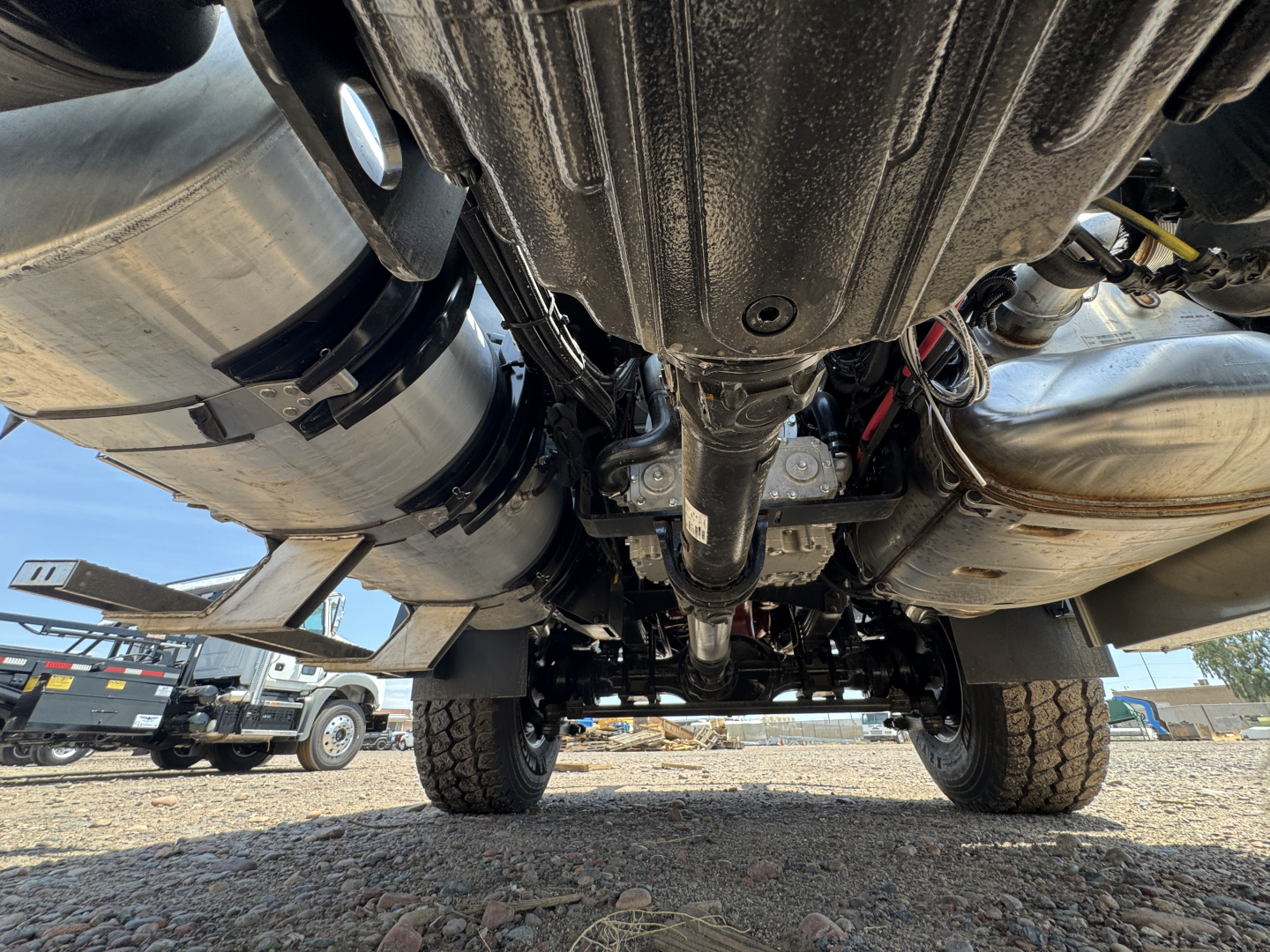 Underbody view of a 2027 Mack GR44B cab and chassis showing drivetrain and suspension components.