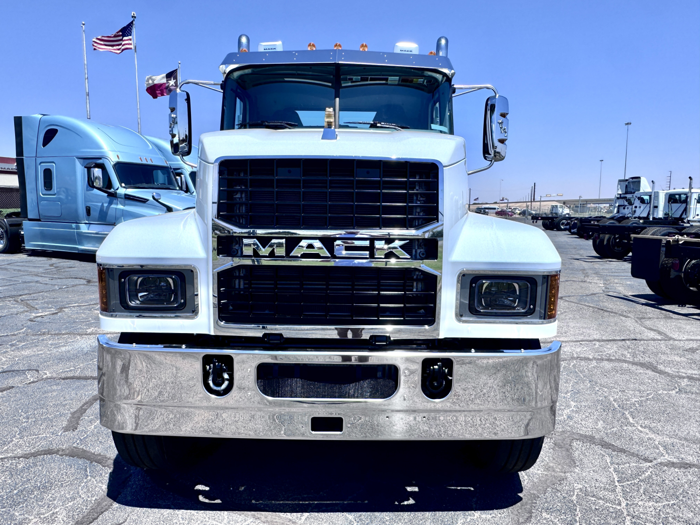 Mack PI64T truck front view showing bold grille and chrome bumper.