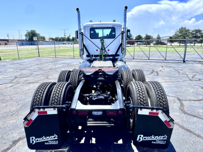 Rear view of a new 2027 Mack PI64T truck chassis with dual rear axles, fifth wheel, and mud flaps labeled Bruckner's Truck & Equipment.