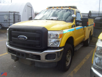 Ford F-350 utility truck with plow showing front grille and yellow body with blue stripe.