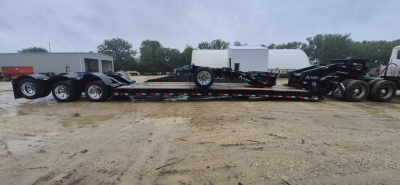 Trailer chassis of a 2027 Alpha A110HDG-E hyd detachable extendable lowboy trailer with multiple axles and a detachable gooseneck.