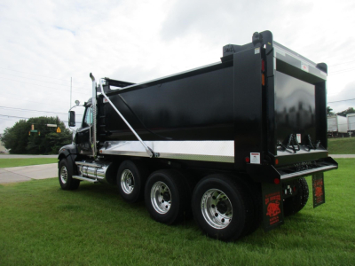 Western Star 49X dump truck in side/back view showing black dump body and dual rear axles.