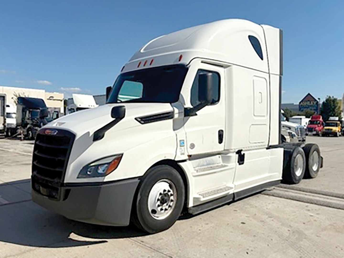 Freightliner Cascadia126 tractor drivetrain cab side view with white paint, decal-less, fuel tanks, and wheels visible.