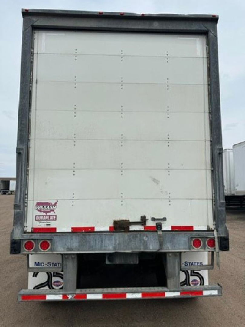 Rear view of a 2016 Wabash trailer showing closed white cargo doors and bumper with Md-State license plates and reflectors.