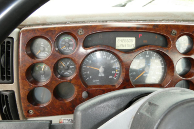 Dashboard of a 2006 Mack CHN613 showing instrument cluster with gauges and digital odometer. Text visible includes '8426606' and '063762' on the digital readout, various gauge labels around, and a woodgrain panel.