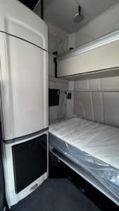 Peterbilt 579 sleeper cab interior showing bunk bed and storage cabinets.