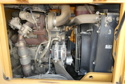 Industrial diesel engine compartment of a Master Craft C08-17166 lift truck showing turbocharged engine, alternator, radiator, hoses, and fan assembly.