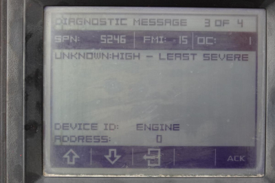 Diagnostic display screen showing messages: SPN 5246 FMI 15 OC 1 with UNKNOWN: HIGH - LEAST SEVERE. Device ID: ENGINE, Address: 0, arrows and ACK button.