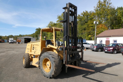 Master Craft C08-17166 forklift in service view with lifting arms raised, side view showing tires and forks.
