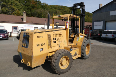 Master Craft C08-17166 forklift in yard showing MC-801 and Tier IV labels, large front tires, rear counterweight with serial TIER IV MC-801 and blue Kawasaki-style markings, cab area, lifting mast, general service area.
