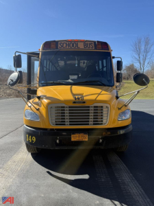 School bus front view showing yellow Freightliner passenger bus with 'SCHOOL BUS' sign, large grille, mirrors, and 149 numbers on bumper; license plate area visible.