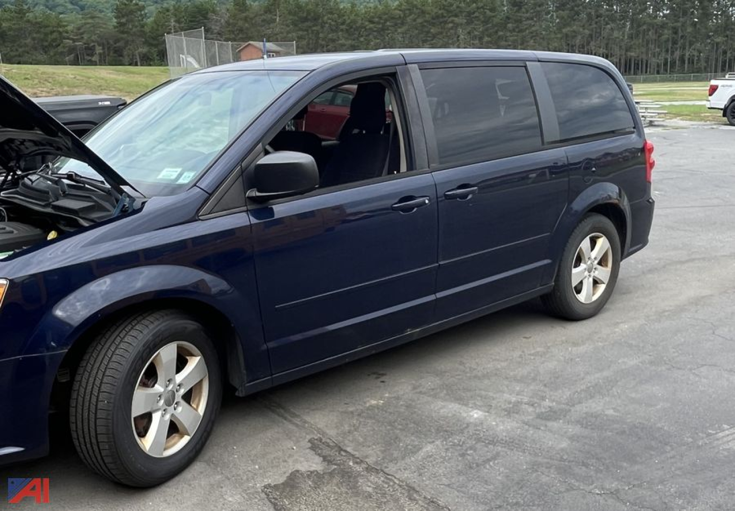 Minivan: 2013 Dodge Grand Caravan with hood open showing passenger side, blue exterior, black windows, silver wheels.