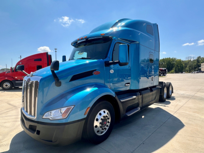 Peterbilt 579 truck in blue, side view showing aerodynamic cab and sleeper.