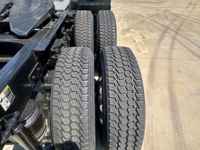 Peterbilt 579 chassis showing twin rear axles with treaded tires and suspension components visible.