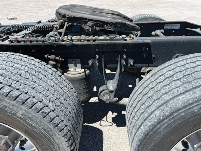 Chassis and fuel area of a used 2015 International ProStar tractor chassis showing dual rear axles and undercarriage components.