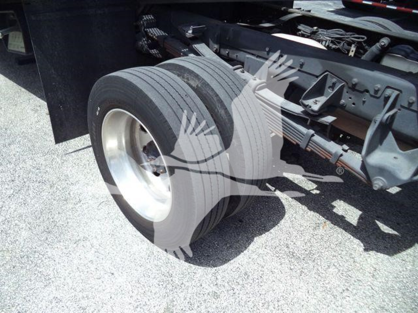 Dual rear tires of a Ram 5500 rollback truck with Hitch and chassis visible, no legible branding or text.