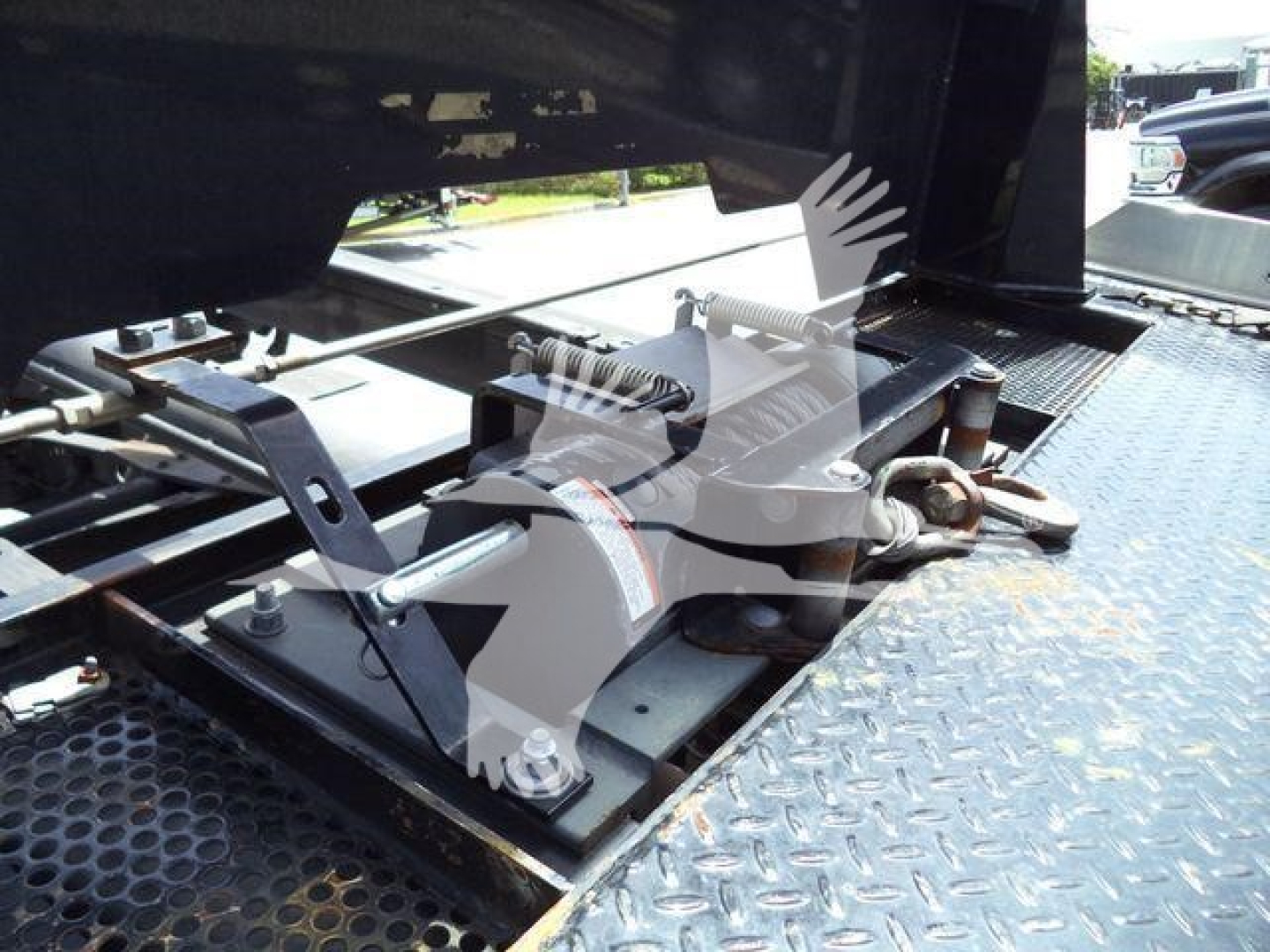 Ram 5500 rollback equipment showing hydraulic winch mechanism and platform with diamond plate surface.