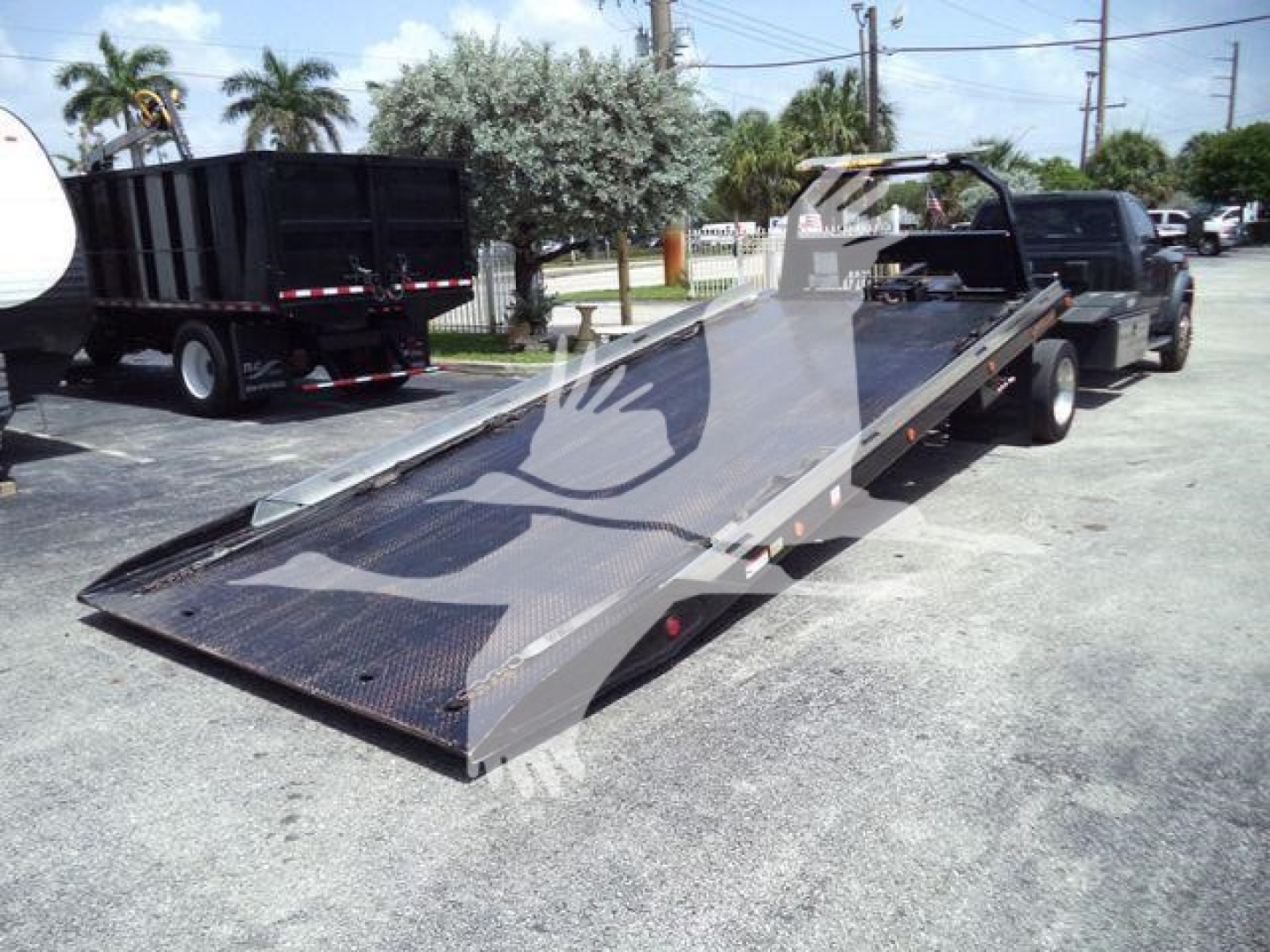 Truck tow rollback rig on a 2022 Ram 5500 SLT in-service with a flatbed tow bed and front cabin area visible.