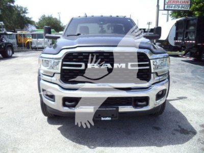 Front view of a silver Ram truck with large grille and bumper; visible watermarked logo on windshield; license plate area shows 'RAM' logo.