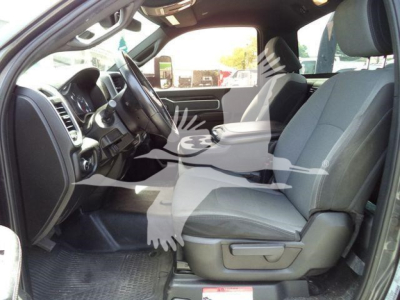 Ram pickup interior with front seats and steering wheel; dashboard and center console visible.