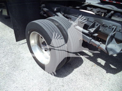 Dual rear tires of a Ram 5500 rollback truck with Hitch and chassis visible, no legible branding or text.