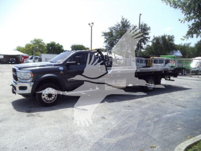 Ram 5500 rollback tow truck in blue showing cab and flatbed with watermark across image