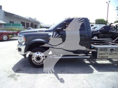 Side view of a black 2022 Ram 5500 rollback truck with a large watermark image of an eagle overlaying the cab area.