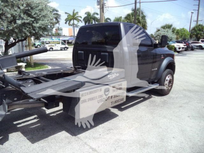Ram 5500 rollback tow truck rear and cab with wheel on right, stock decals and towing apparatus visible.