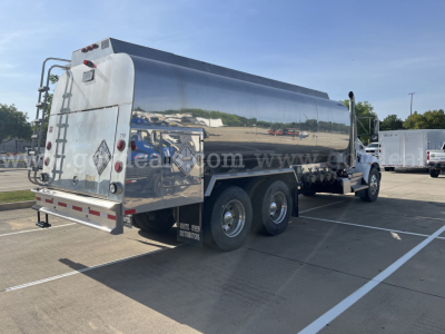 Kenworth T370 dump truck rear and side view showing polished stainless tanker body with reflective surface and dual rear wheels on each side.