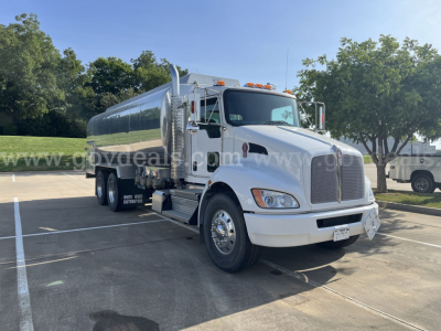 Kenworth T370 vacuum/ tanker truck in a parking lot shown from front-left angle with chrome fuel tank and white cab.