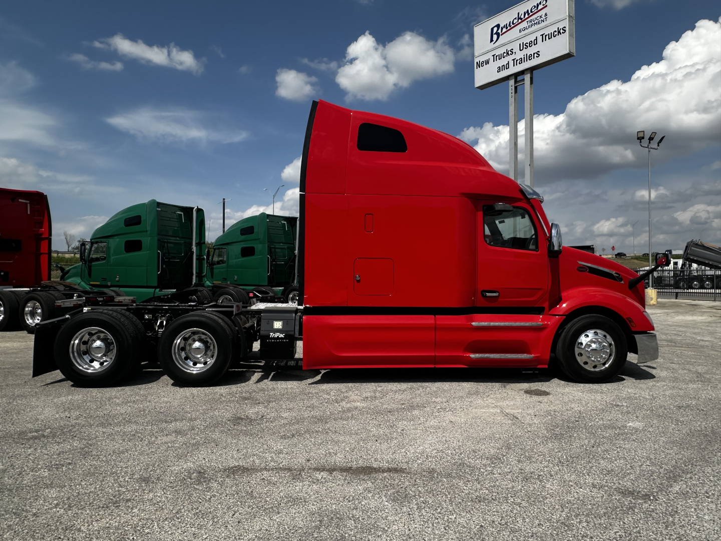 Peterbilt 579 truck in red side view showing sleeper cab and chassis with multiple axles.