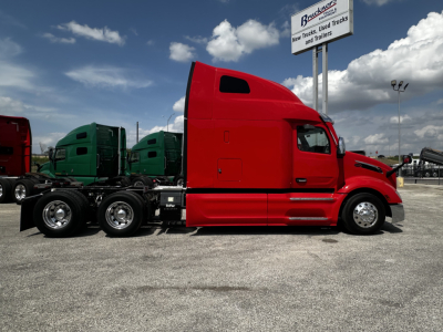 Peterbilt 579 truck in red side view showing sleeper cab and chassis with multiple axles.