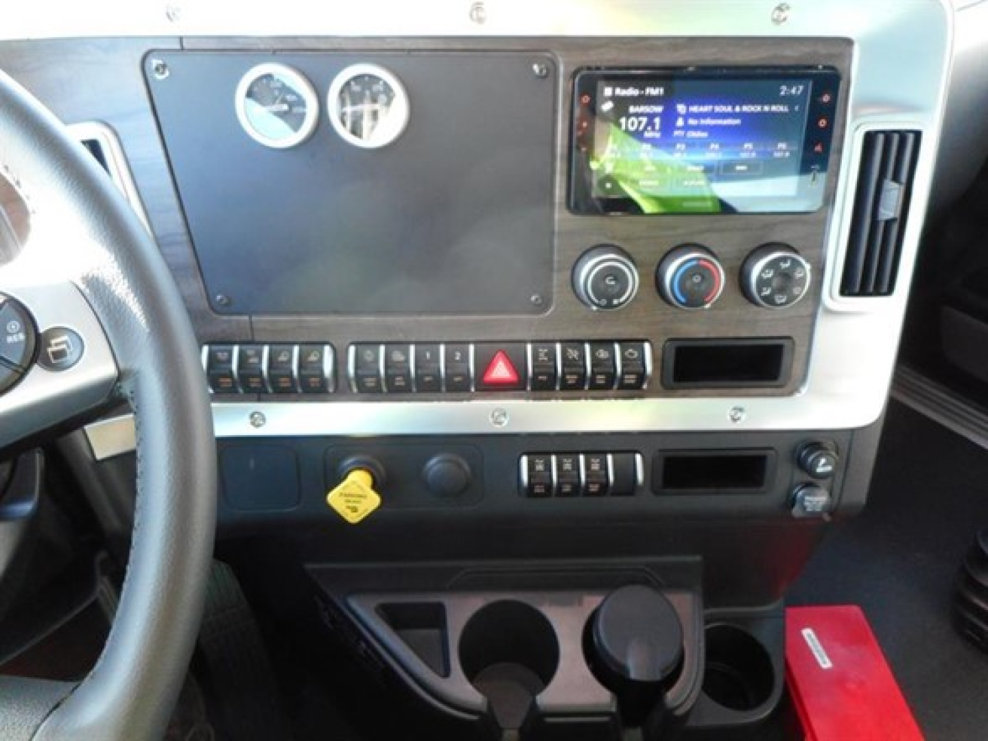 Western Star truck cabin dashboard with gauges, touchscreen infotainment, and control panel.