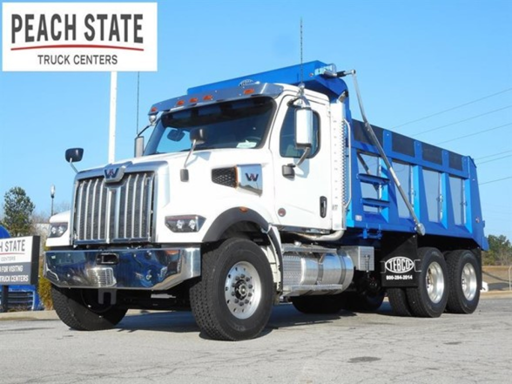Western Star 47X dump truck showing front and side profile with blue dump body and Peach State Truck Centers sign
