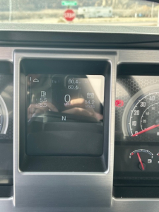 Mack MD7 instrument cluster showing digital gauge display and fuel/voltage readouts.