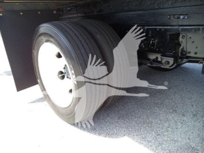 Isuzu NPR-HD truck rear dual rear wheels showing spare wheel area and undercarriage, with tires and wheel well visible.