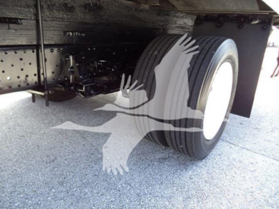 Isuzu NPR-HD truck rear dual rear wheels showing undercarriage and tire with mudguard.