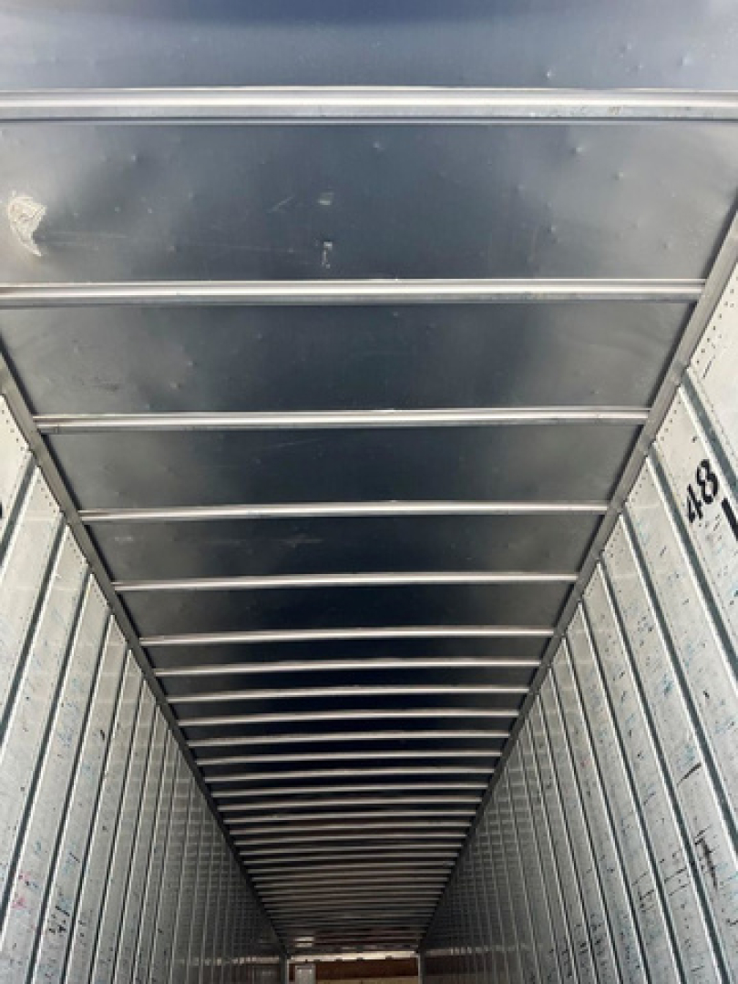 Van interior cargo area showing metal sidewalls and ceiling ribs.