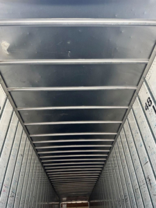Van interior cargo area showing metal sidewalls and ceiling ribs.