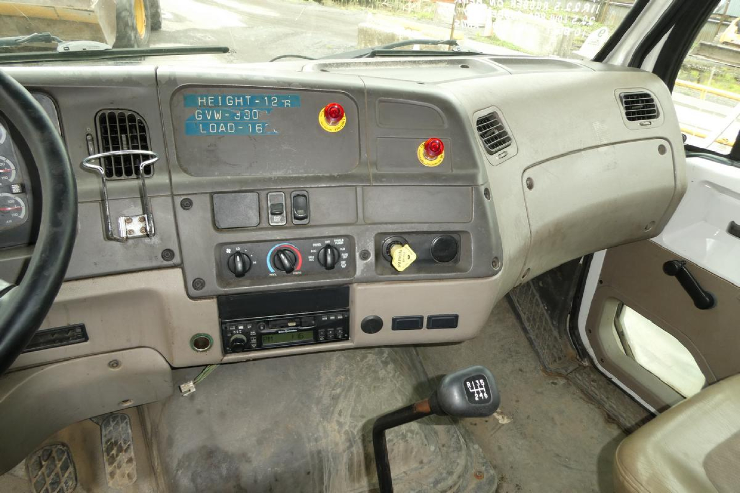 Truck interior dashboard of a 2006 Sterling ACTERRA showing steering wheel, instrument panel, center stack, gear shifter, and control knobs.
