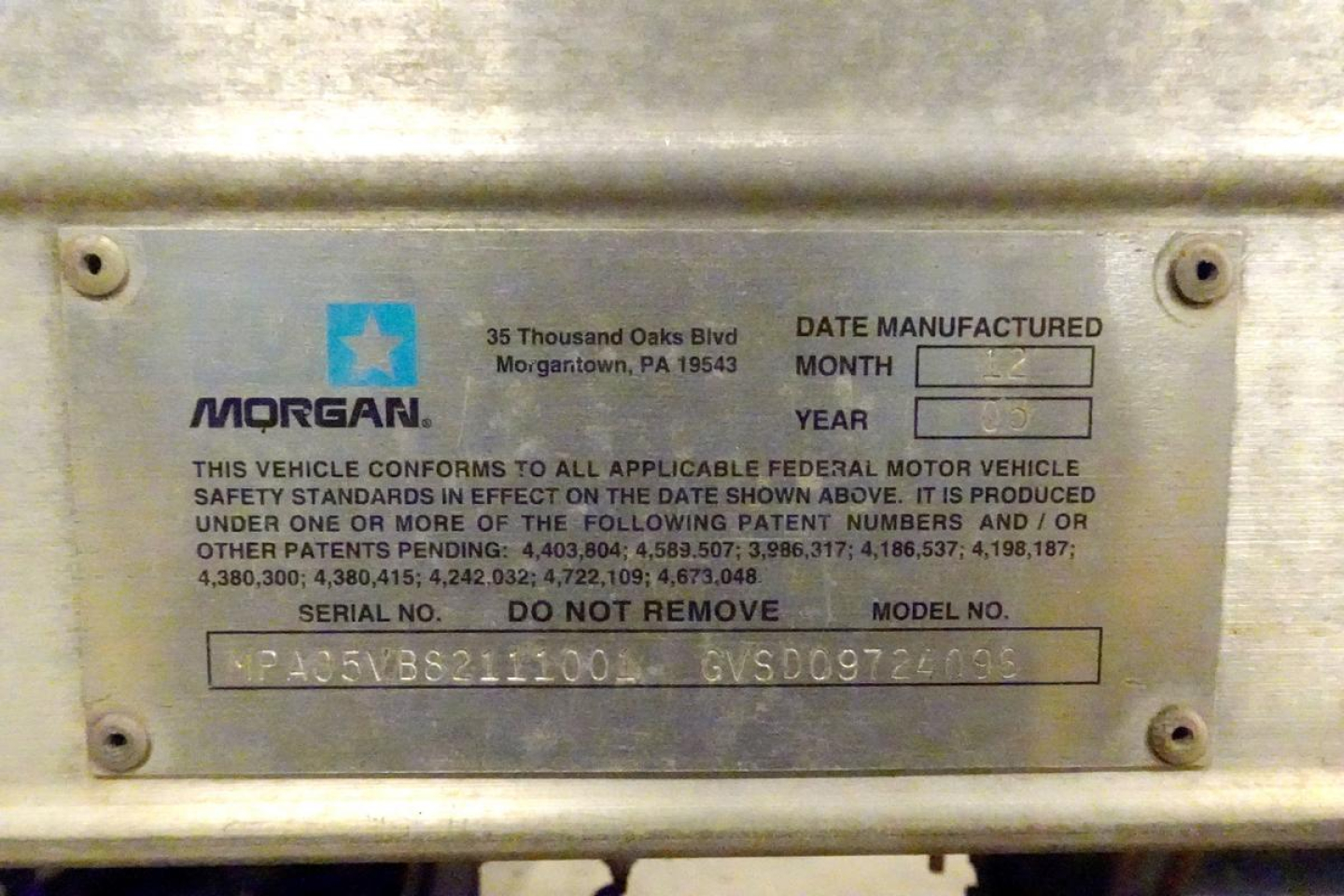 Metal data plate on vehicle shows Morgan brand with VIN/serial details and patent numbers. Plate includes date manufactured fields and model/serial numbers.