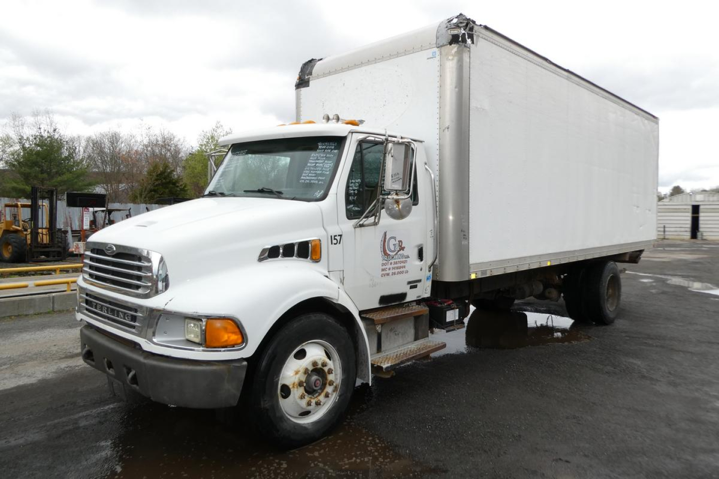 Commercial truck with box body showing Sterling ACTERRA front, white cab, large box cargo area. Visible text on door: C S? and numbers. Nozzle lights and bumper. VIN not legible in image.
