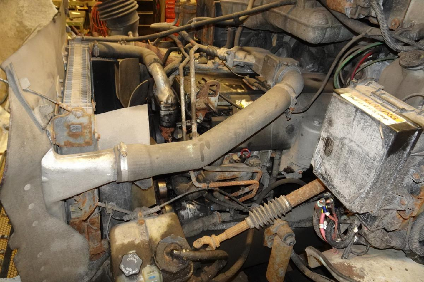 Sterling Acterra engine bay showing radiator, hoses, and battery with wiring and exposed components.