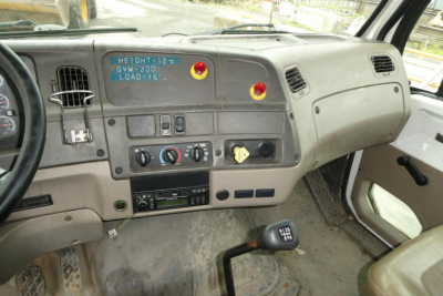 Truck interior dashboard of a 2006 Sterling ACTERRA showing steering wheel, instrument panel, center stack, gear shifter, and control knobs.
