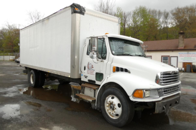 Box truck with a white cab and large box body, Sterling ACTERRA, side view showing cargo box and front grille.