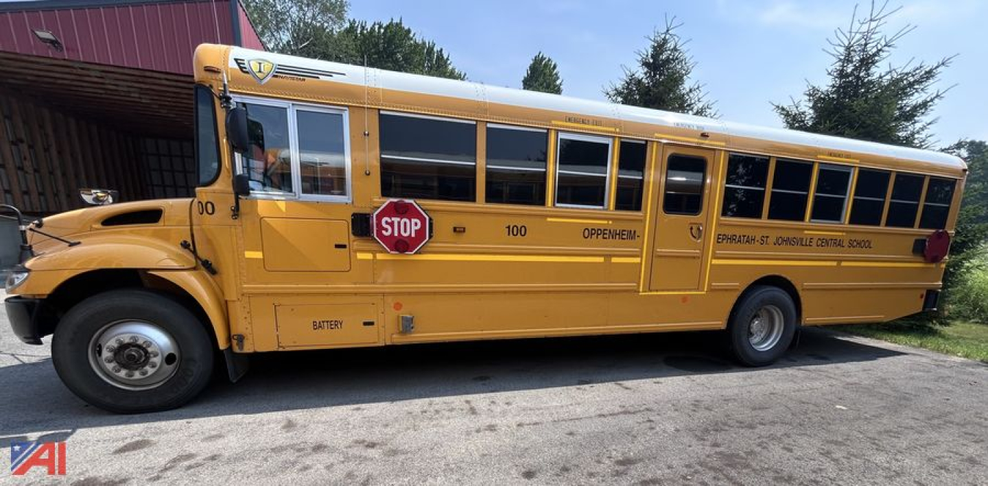 School bus side view showing yellow CE Series bus with stop sign extended and doors closed; visible text includes 100 bus number, Openen..., IC Corporation branding on the side.